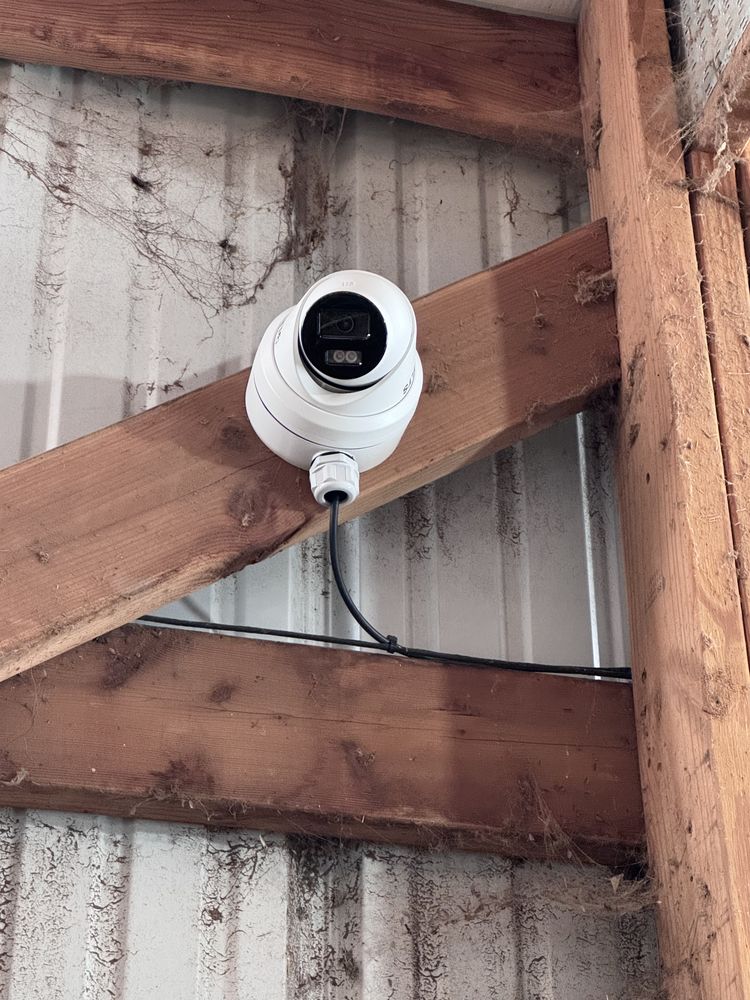 PTZ dome camera mounted on a commercial building eave
